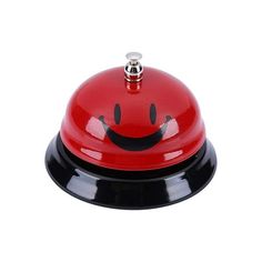 a red and black bell with a smiling face on it's top is shown