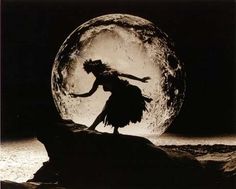 a woman is dancing in front of the moon