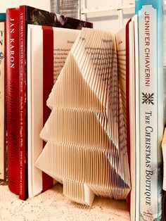 several books stacked on top of each other with a christmas tree made out of them