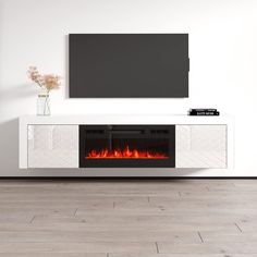 an entertainment center with a fireplace in the middle and a flat screen tv above it