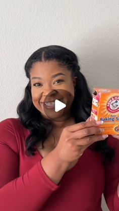 a woman is holding up a box of baby powder with her mouth open and tongue out