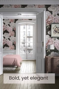 a bedroom with pink flowers on the wall and an open door leading to another room