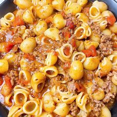 a skillet filled with pasta and meat sauce