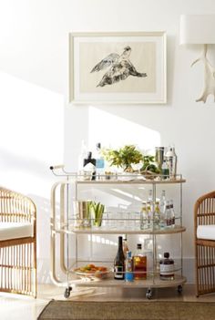 a bar cart with drinks on it in a living room