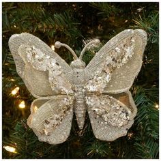 an ornament shaped like a butterfly on a christmas tree