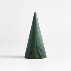 a green cone shaped vase sitting on top of a white table