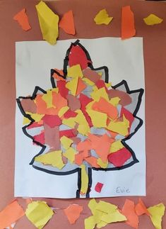 the paper is cut out to look like a leaf and leaves are scattered around it