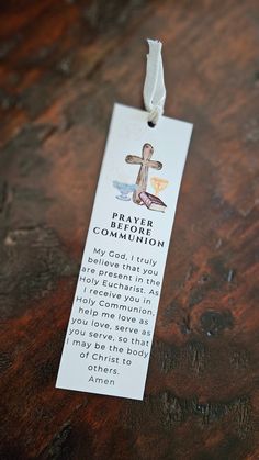 a wooden table with a white tag that says prayer for the community on it and a cross