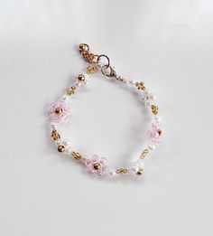 Bracelet length: 7.5 inches Pink Flower Width: 0.375 inches White Flower Width: 0.25 inches Adjustable length: 0.5 inches Material: Nylon thread, plastic and brass beads Can be personalized: No Adjustable Rose Gold Flower Beaded Bracelets, Beaded Flower Bracelet, Giraffe Crochet, Cary Nc, Brass Beads, Doll Jewelry, Pink Jewelry, Flower Bracelet, Plastic Beads