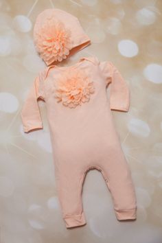 Peach baby girl romper with matching hat for your adorable little baby! Light cotton fabric is perfect to spring or summer months... Beautiful large chiffon , approximately 5 in, on the chest and matching hat... The flower is very fluffy and large, so pretty...snaps on the bottom for easy dressing.. avialble in 6-12ms only HAND WASH ITEM PLEASE DO NOT COPY.. BY PURCHASING THIS ITEM, YOU ARE AGREEING TO MY SHOP POLICIES www.etsy.com/shop/jacqueline225/policy PLEASE DO NOT COPY If you have any que Cute Cream Onesie For Spring, Spring Baptism Cotton Onesie, Pretty Snaps, Baby Light, Matching Hat, Casual Rompers, Easy Dressing, Girls Clothing Sets