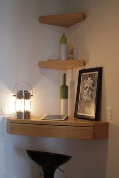 a shelf that has some bottles on top of it and a lamp next to it