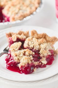 a slice of pie on a white plate with a fork in front of the pie