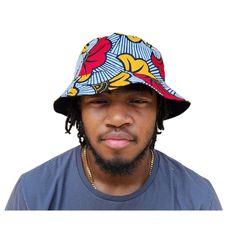 A unisex bucket cap made using authentic Ankara fabric. 58cm. Ankara, also known as African wax print or Dutch wax print, is a fabric characterized by vibrant patterns and colors. The fabric is made through a wax-resist dyeing technique called batik which creates distinct and colorful patterns. Ankara fabric is used to make a wide range of clothing and accessories, including dresses, skirts, shirts, and hats. Each pattern carries cultural meanings and stories making pieces made from this fabric not just fashion items but also carriers of African heritage and identity. Casual Multicolor Cotton Bucket Hat, Multicolor Reversible Cotton Sun Hat, Reversible Multicolor Cotton Sun Hat, Multicolor Reversible Cotton Bucket Hat, Reversible Multicolor Cotton Bucket Hat, Large Framed Artwork, Dutch Wax Print, Raffia Sun Hat, Resist Dyeing