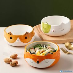 two bowls with food in them on a table