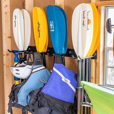 there are many surfboards hanging on the wall