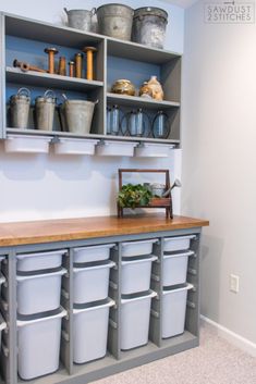 the shelves are filled with plastic containers and buckets on top of them, along with other storage bins