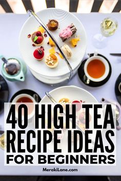 a table topped with plates of food and cups of tea on top of each other