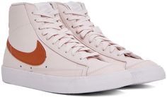 Mid-top buffed leather sneakers in pink. Metallic orange trim throughout. · Lace-up closure · Textile logo patch at padded tongue · Padded collar · Swoosh appliqué at sides · Logo embroidered at heel tab · Treaded rubber sole Please note that this item may be shipped only within North America. Supplier color: Light soft pink/Metallic Blazer 77, Metallic Orange, Mid Sneakers, Textile Logo, Pink Metallic, Mid Top, Pink Blazer, Nike Pink, Logo Embroidered