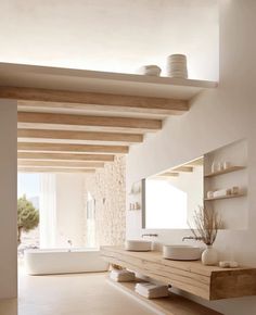 a bathroom with two sinks and a large mirror on the wall next to a bathtub