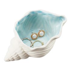 a blue and white bowl with two rings in it