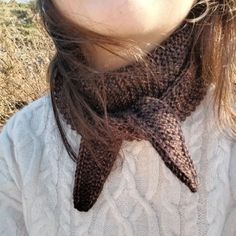 a close up of a person wearing a knitted scarf with a starfish on it