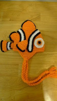 an orange crocheted nemo hat with black and white stripes