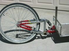 a bicycle is attached to a trailer on the concrete floor next to a garage door