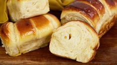 several pieces of bread sitting on top of a wooden cutting board