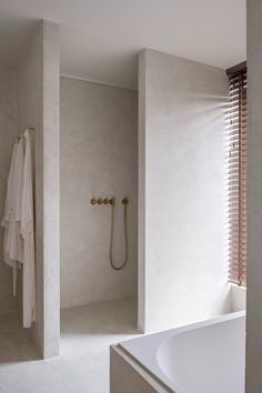 a bathroom with a tub, shower and window