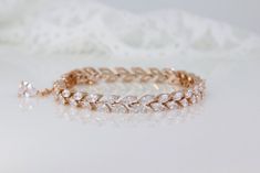 "The timeless 'Hayley' bracelet is handcrafted with superb quality zircon crystals and set in a staggered marquise design.  This delicate accessory coordinates perfectly with our earring range, for a stunning matching look.  Set in a 16K rose gold tarnish-resistant base. * Lengths- 6\" & 7\" * Fitted with a lobster clasp and optional small extender  * Shopping for your bridal party? Access special pricing by contacting us. * Tarnish free, nickel free * Shopping for your bridal party? Access spec Rose Gold Cubic Zirconia Bracelets With Diamond Cut, Rose Gold Cubic Zirconia Bracelet With Diamond Cut, Rose Gold Diamond Cut Bracelet With Cubic Zirconia, Dazzling Rose Gold Bracelets With Diamond Cut, Dazzling Rose Gold Diamond Cut Bracelets, Rose Gold Hand Set Tennis Bracelet For Wedding, Elegant Rose Gold Crystal Bracelet For Anniversary, Rose Gold Diamond Bracelet With Accents For Wedding, Rose Gold Tennis Bracelet For Wedding