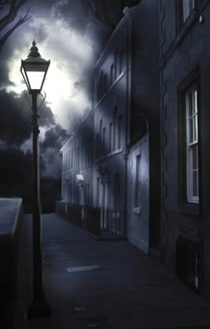 a street light sitting on the side of a road next to tall buildings under a cloudy sky