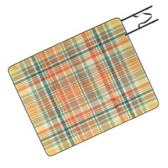 an orange, yellow and green plaid pattern cutting board with tongs attached to it