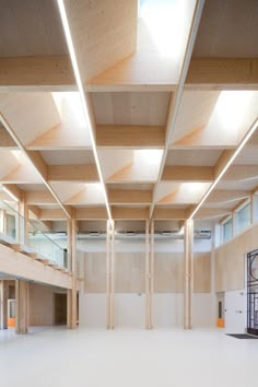 an empty building with wooden beams and windows