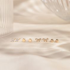 Delight in the dainty sparkle of our Tiny Cubic Zirconia Basket Stud Earrings! These simple earrings may be little, but they pack a big shine. With a dazzling 7a quality cubic zirconia gemstone set in 14k solid gold, this pair is as perfect for special occasions as it is for every day. Shower safe, gentle on sensitive skin, and durable, these earrings bring a bit of sparkle with you wherever you go! DETAILS 14k solid gold studs with 14k butterfly backs 3mm high 7a quality cubic zirconia stones P Love Knot Ring, Diamond Initial Necklace, Solid Gold Bracelet, Tiny Bow, Minimal Earrings, Diamond Jewelry Necklace, Solid Gold Necklace, Solid Gold Earrings, Heart Stud Earrings