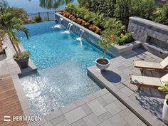 an outdoor swimming pool surrounded by trees and plants