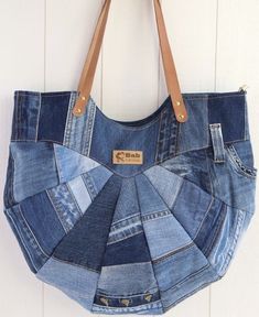 a purse made out of jeans hanging on a wall