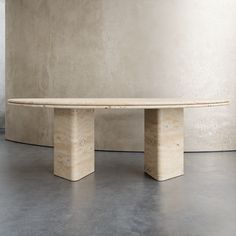 a marble table sitting in front of a wall with no one around it on the floor