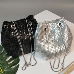 This Sequined Bucket Bag is a stylish and versatile accessory. The chic crossbody design makes it easy to carry and the chain shoulder strap adds a touch of elegance. The sequined exterior adds a touch of glam to any outfit. Perfect for a night out or special occasion. Introducing our Sequined Bucket Bag, an eye-catching and versatile addition to any outfit. With a crossbody chain and shoulder bag design, this bag offers both functionality and style. The sequined exterior adds a touch of glamour, perfect for day or night. Upgrade your look with this must-have accessory. Silver Evening Bags With Chain, Silver Evening Bag With Chain Detail, Evening Metal Chain Shoulder Bag, Party Purse Handbags, Evening Crossbody Bucket Bag With Silver-tone Hardware, Luxury Black Sequined Bags, Prom Purse, Snakes, Drawstring Bucket Bag