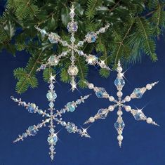 a snowflake ornament hanging from a christmas tree