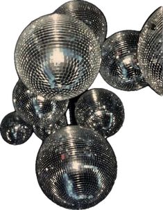 several shiny disco balls hanging from the ceiling