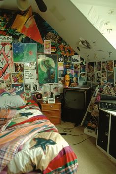 a bed room with a neatly made bed and lots of posters on the wall behind it