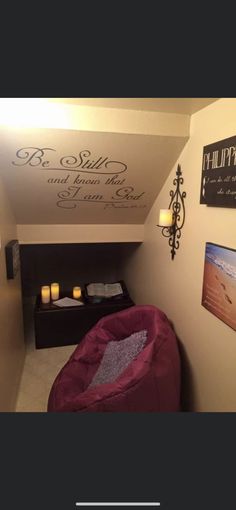 a small room with a bed and some pictures on the wall above it that says, be still and know the story