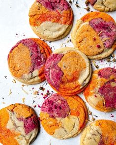 colorful cookies are arranged on a baking sheet