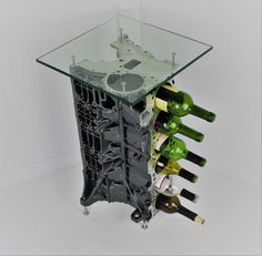 a wine rack that has several bottles in it and is sitting next to a glass table