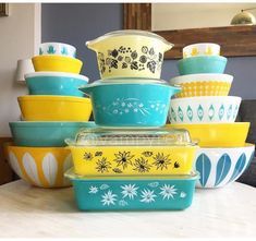 a stack of colorful bowls sitting on top of a table