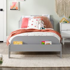 a child's bedroom with a bed, nightstands and toys on the floor