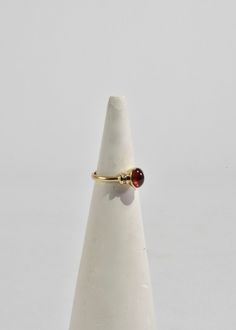 Beautiful vintage gold ring with a polished ruby cabochon and diamond detail. Stamped 10k. Material: 10k gold, ruby, diamond. We recommend storing in a dry place and periodic polishing with a cloth.