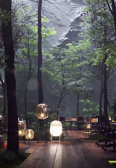 an outdoor area with tables, chairs and lights