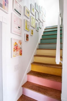 a stair case with pictures on the wall