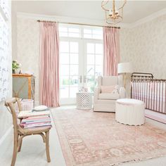 a baby's room with pink and white decor